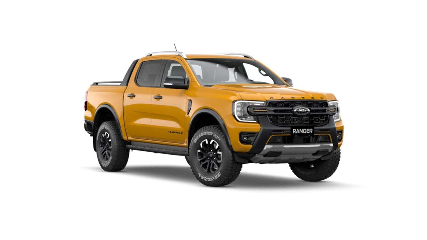 Orange Ford Ranger with bull bar and roof rack — dealership floor